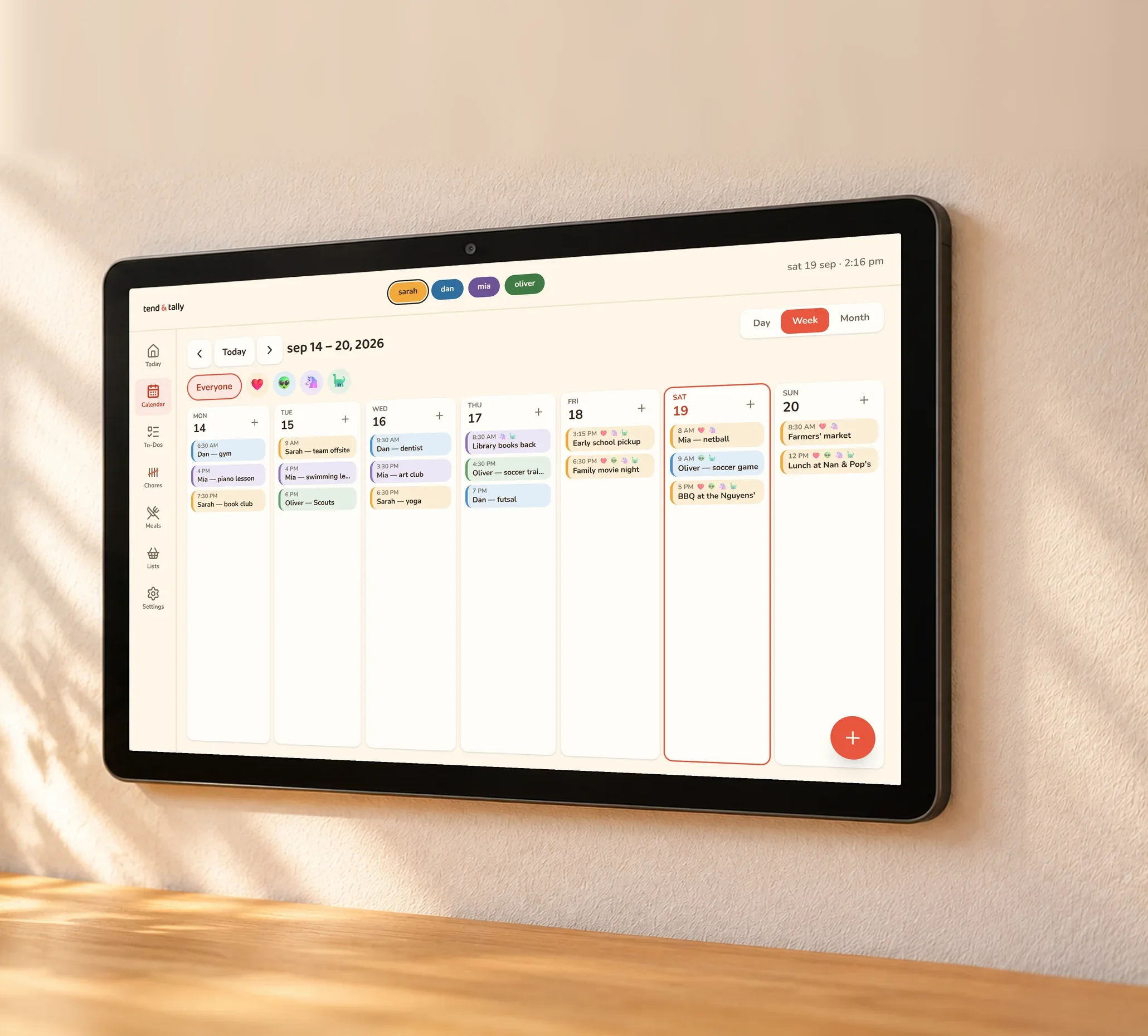 A tablet on a kitchen wall showing a family's week in tend & tally, each person's events in their own colour.